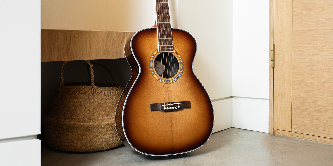 M-260E Deluxe Edge Burst leaning against a vintage wicker cabinent by a wicker chair