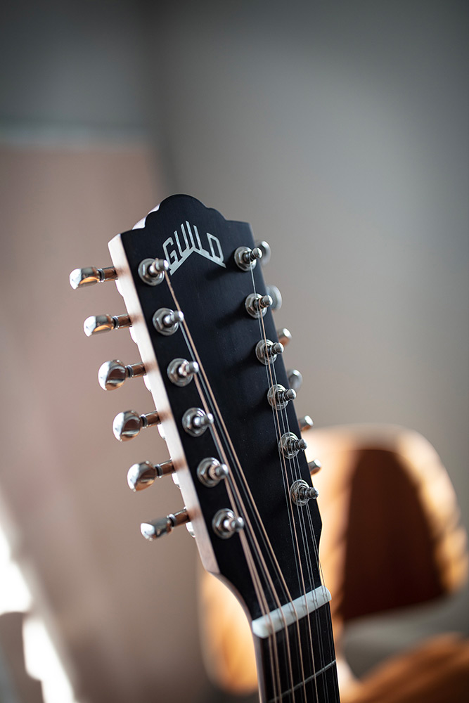 Close-up F-2512E Maple headstock with Guild logo