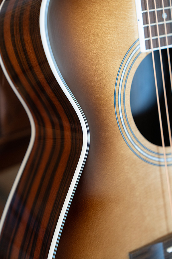 Close-up M-260E Deluxe Edge Burst binding and Striped Ebony side