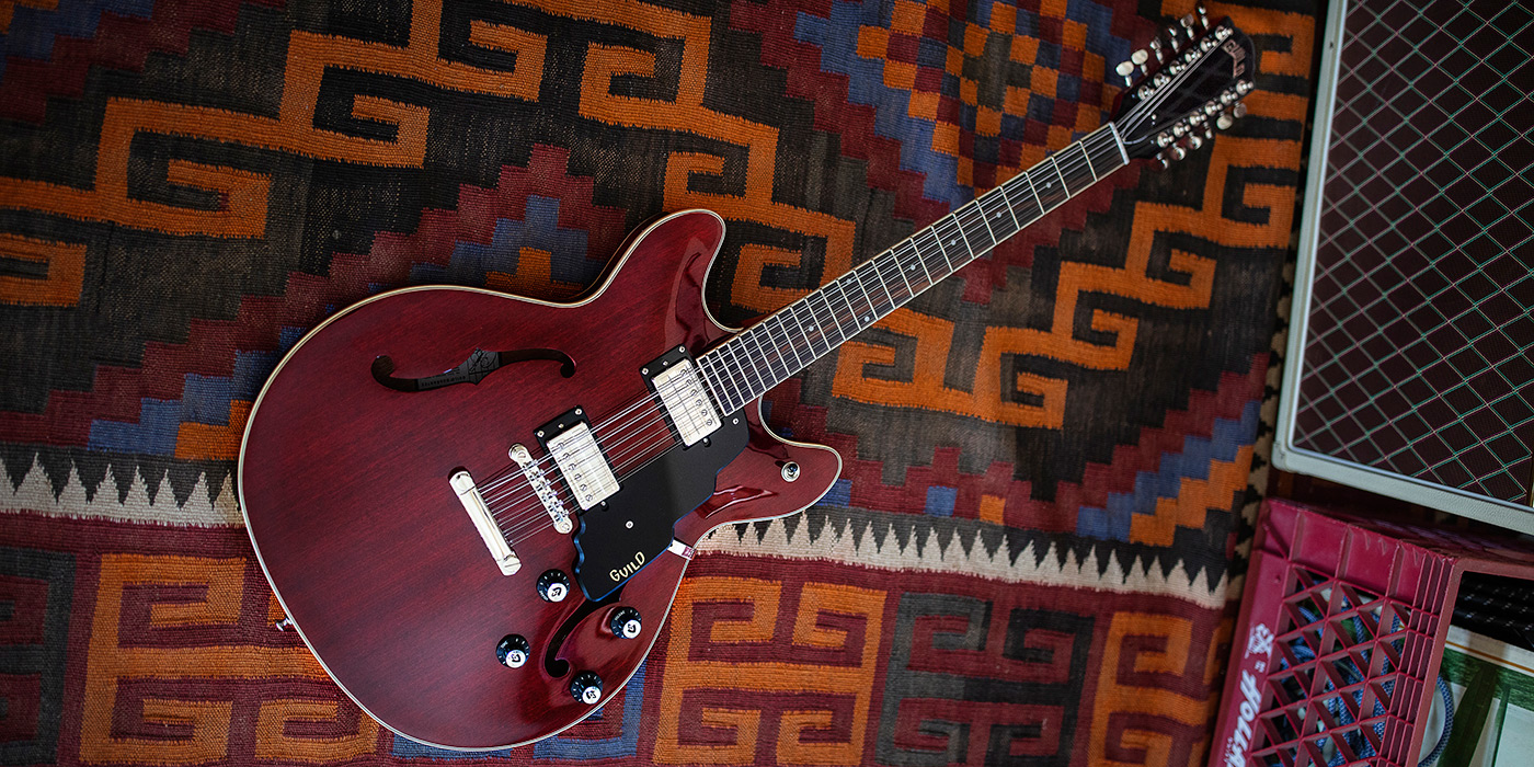 Starfire I-12 Cherry Red electric guitar laying on colorful rug