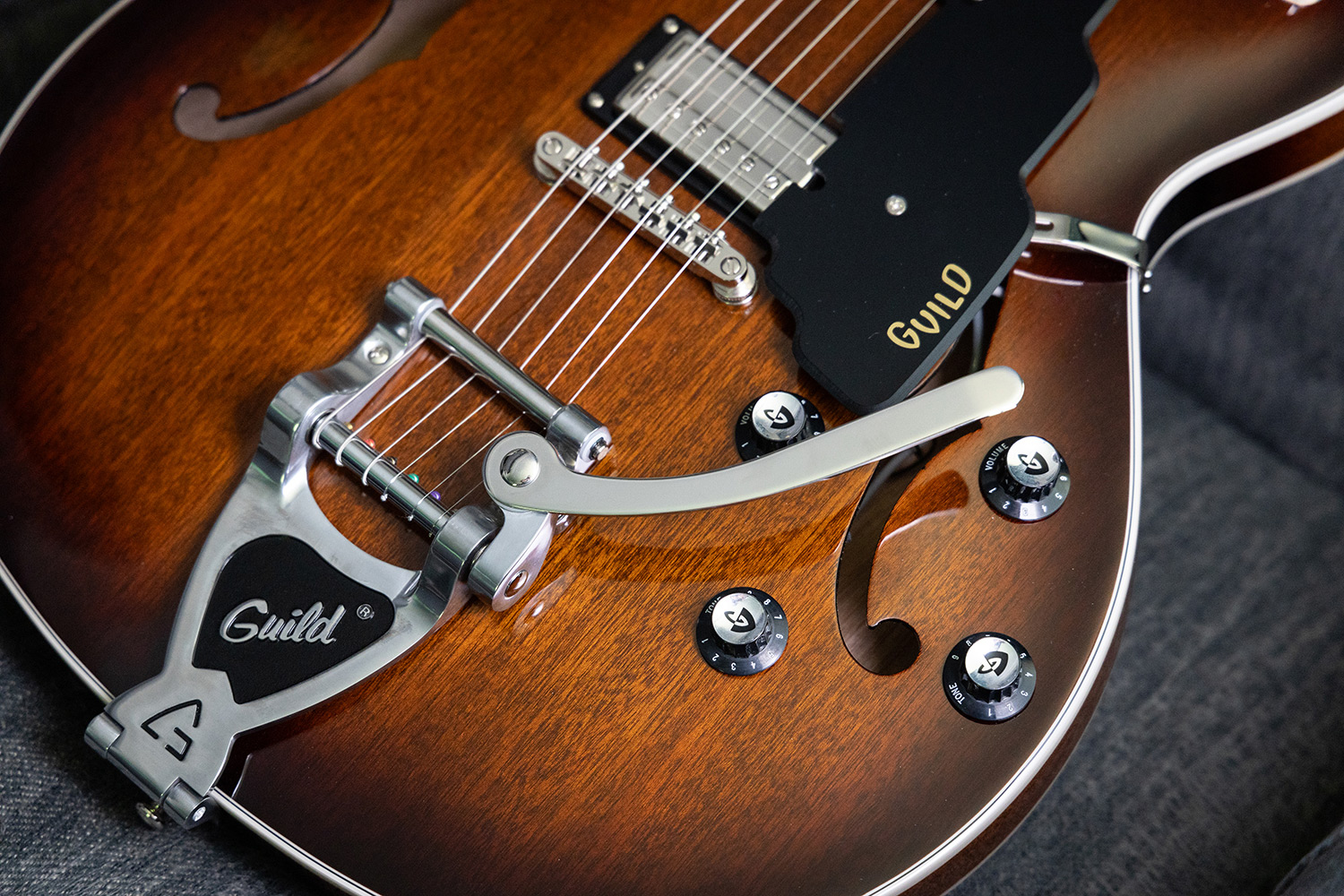 Close-up view of Starfire I DC California Burst body highlighting the knobs and vibrato tailpiece