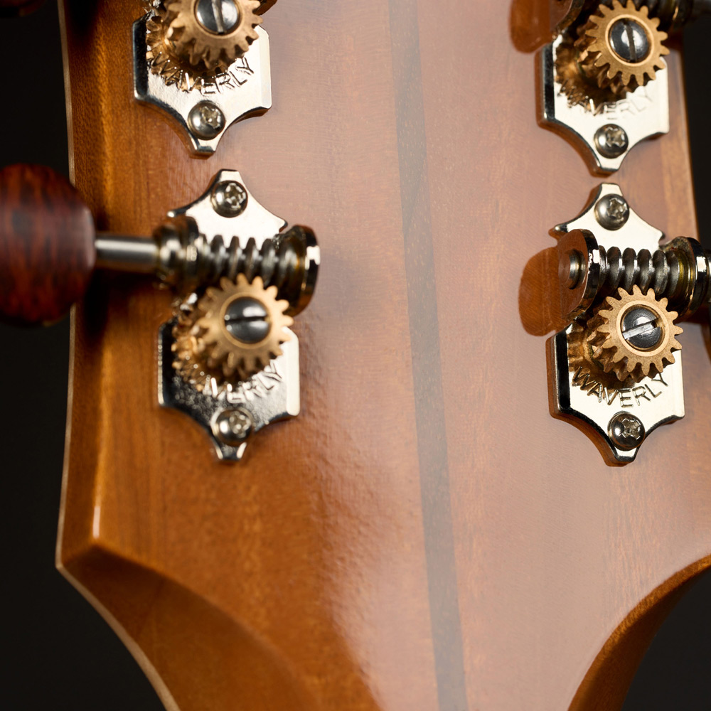 Close-up of VR1 F-40 Au Naturel back of headstock showcasing deluxe tuners with snakewood buttons thumb