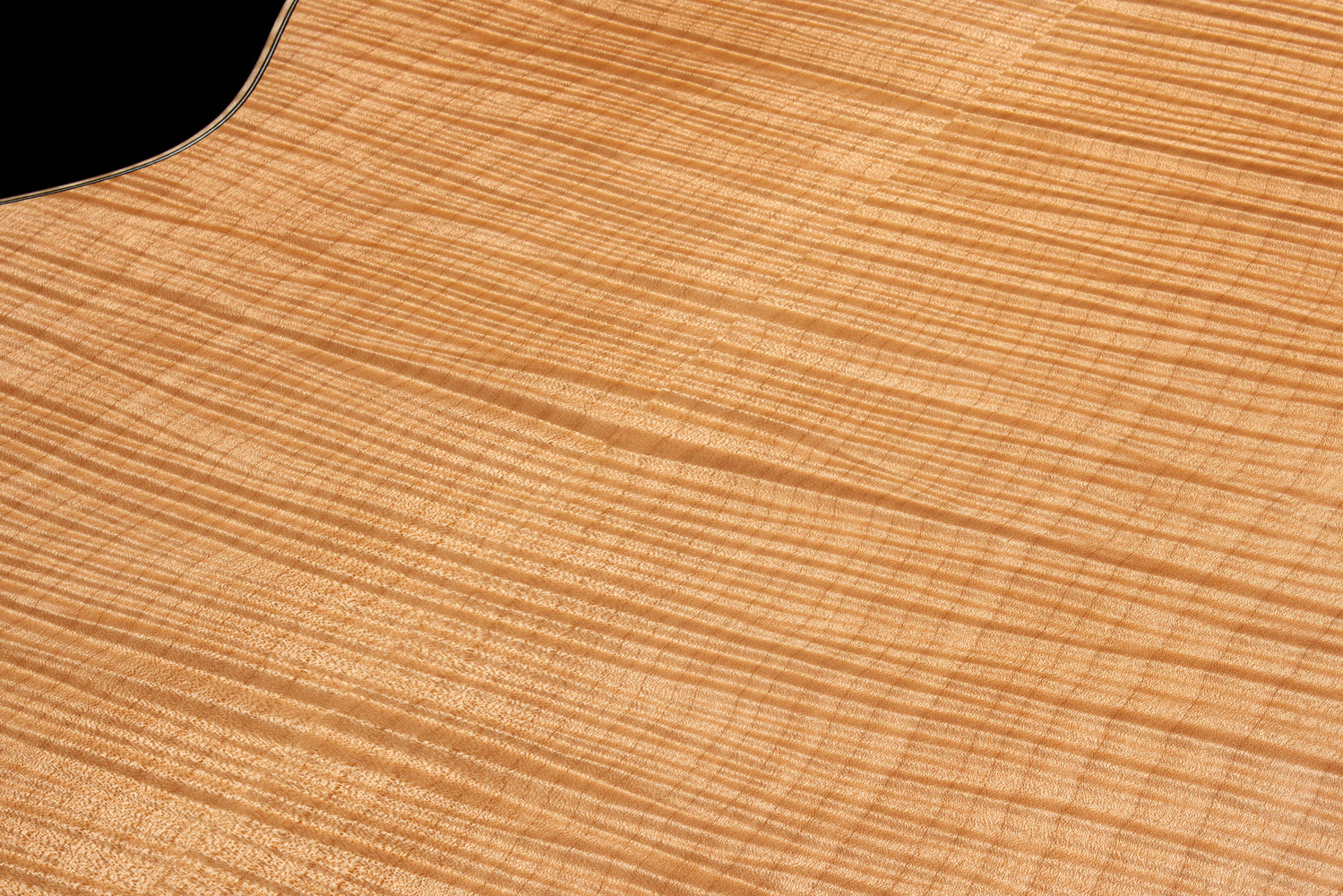 Close-up of VR1 F-40 Au Naturel back showcasing ultra-rare aged solid 5A flame maple