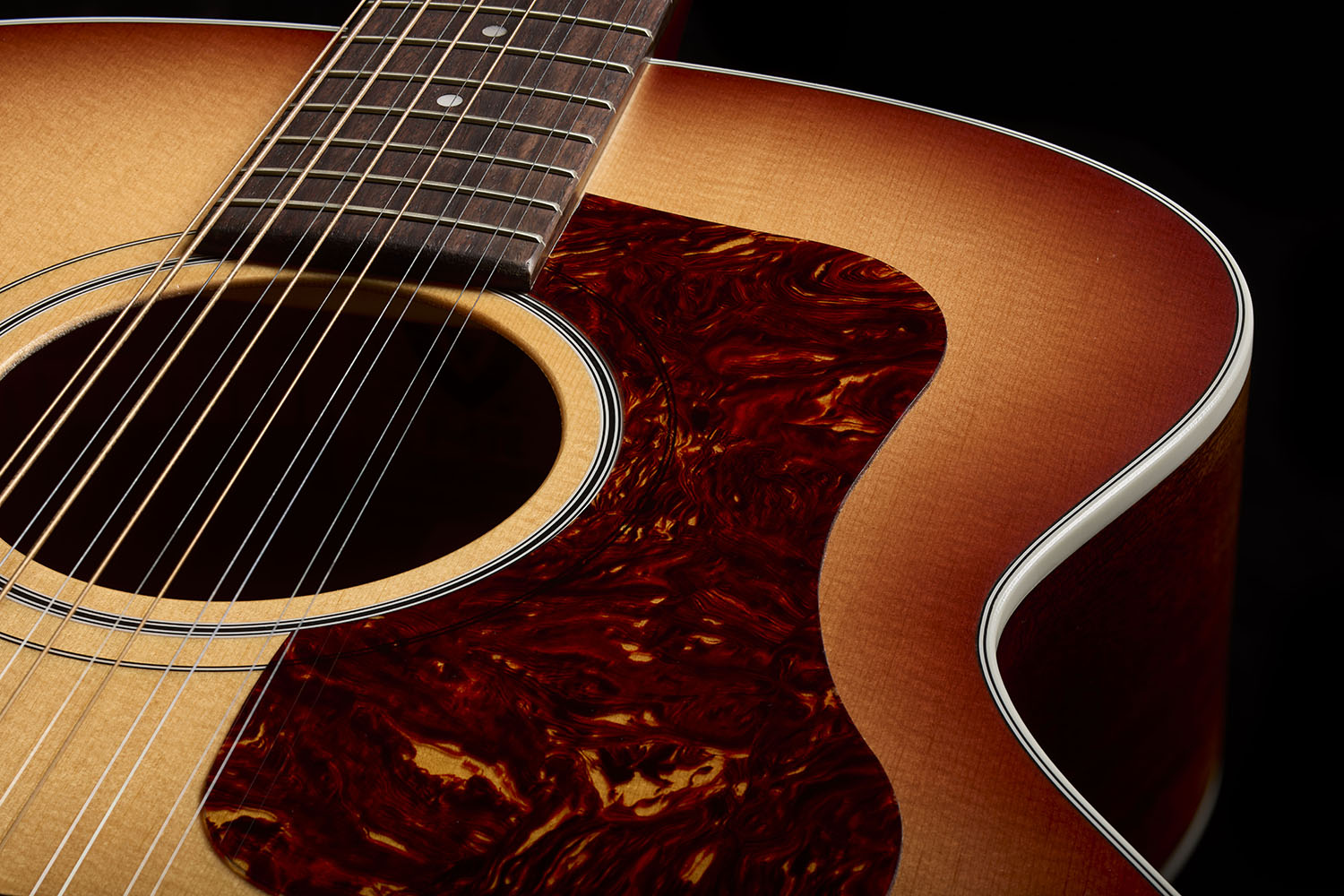 Close-up of F-412 Standard Pacific Sunset Burst soundhole and pickguard