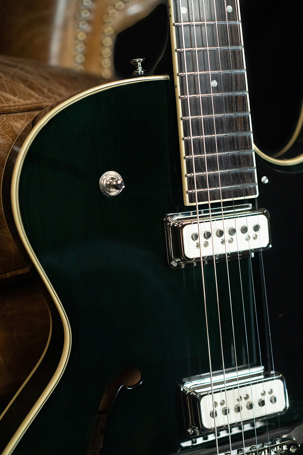 Close up view of Starfire III Dynasonic Emerald Green body curve, pickups and stings