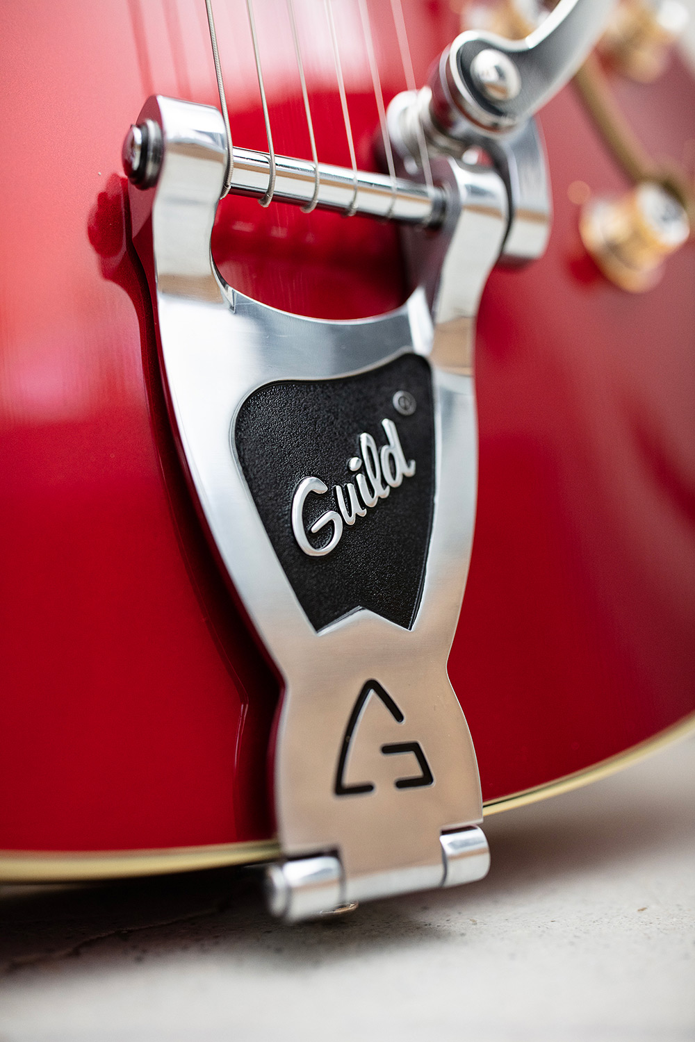 Close up of X-350 Stratford Scarlet Red guitar tailpiece