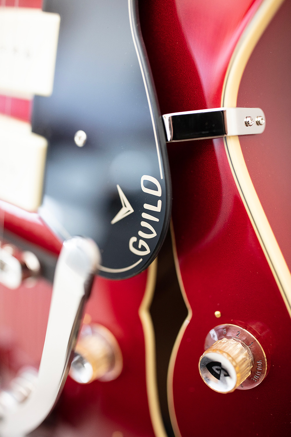 Close up of X-350 Stratford Scarlet Red guitar pickguard