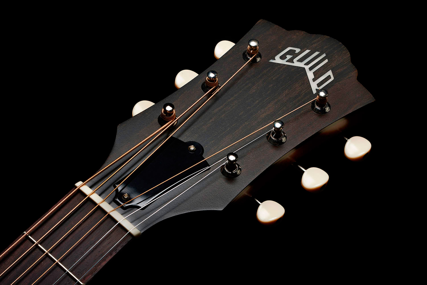 Close-up of front of the M-40 Standard Pacific Sunset Burst headstock with Guild Peak logo