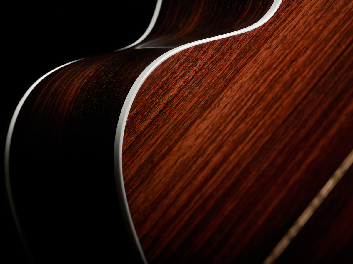 Close-up of M-50 Standard Natural white ABS body binding and solid Indian rosewood back