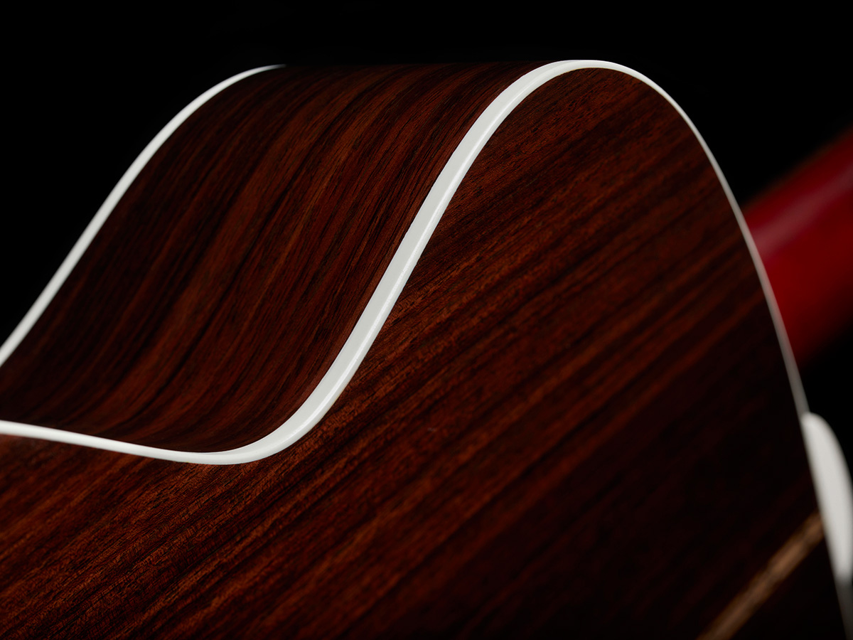 Close-up of M-50 Standard Antique Burst white ABS body binding and solid Indian rosewood back