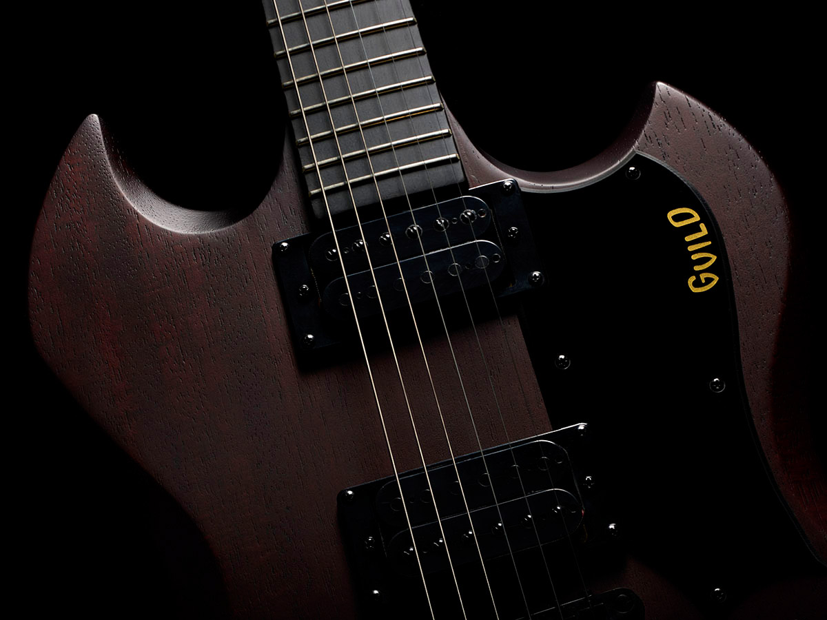 Close-up of Polara Limited Night Edition Vintage Walnut body showcasing solid mahogany body.