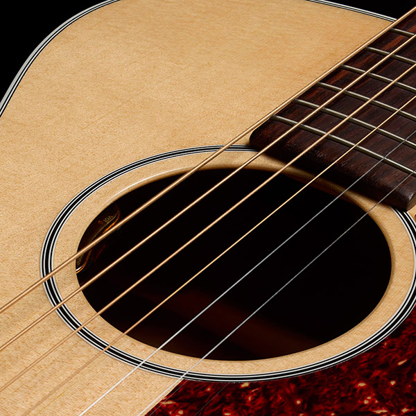 Close-up of M-40E Standard Natural soundhole showcasing L.R. Baggs Element VTC pickup system thumb