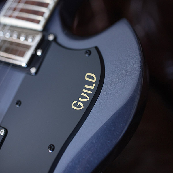 View of Polara Deluxe Canyon Dusk pickguard and Guild logo thumb