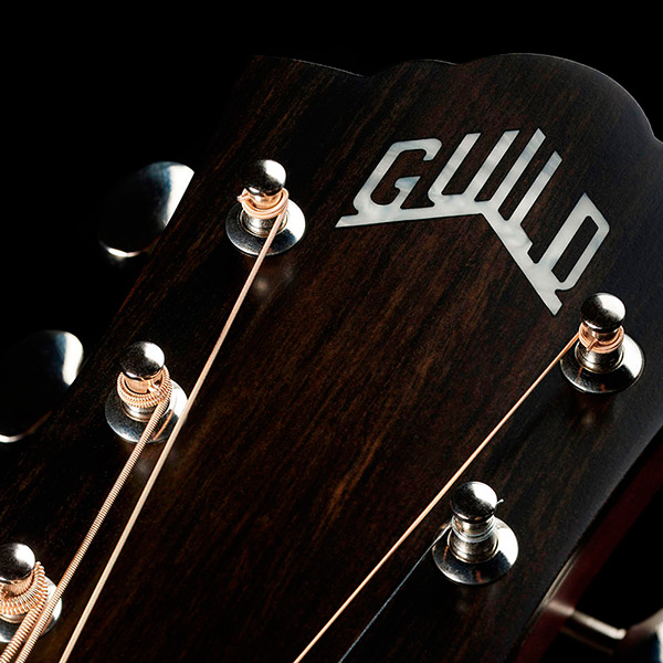 Close-up of front of the M-50 Standard Antique Burst headstock with Guild Peak logo thumb