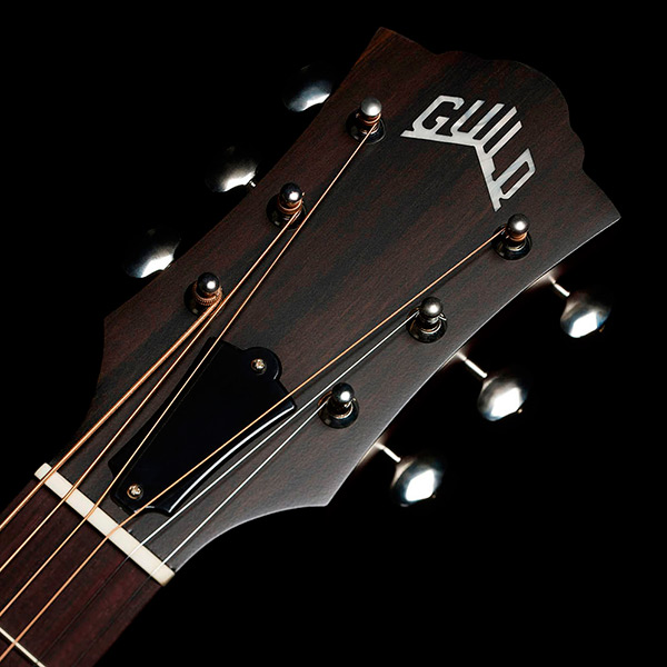 Close-up of front of the M-50 Standard Natural headstock with Guild Peak logo thumb