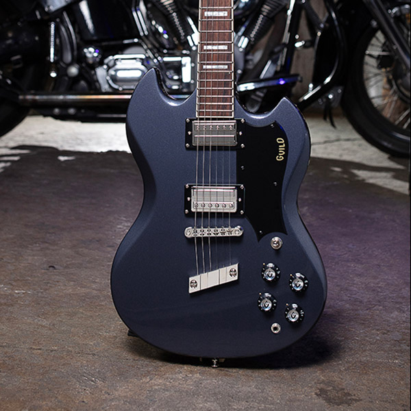 Polara Deluxe Canyon Dusk on a concrete floor with motorcycle behind thumb