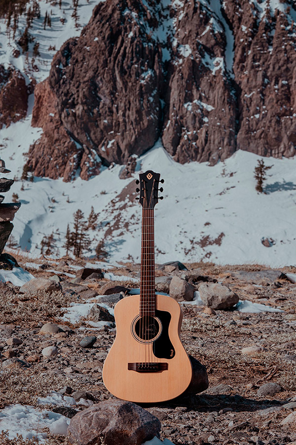 Travel Spruce acoustic guitar in a rocky snowy landscape thumbnail