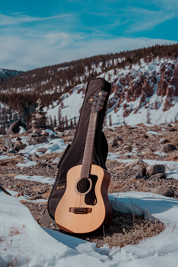 Travel Spruce acoustic guitar with gig bag  in a rocky snowy landscape thumbnail