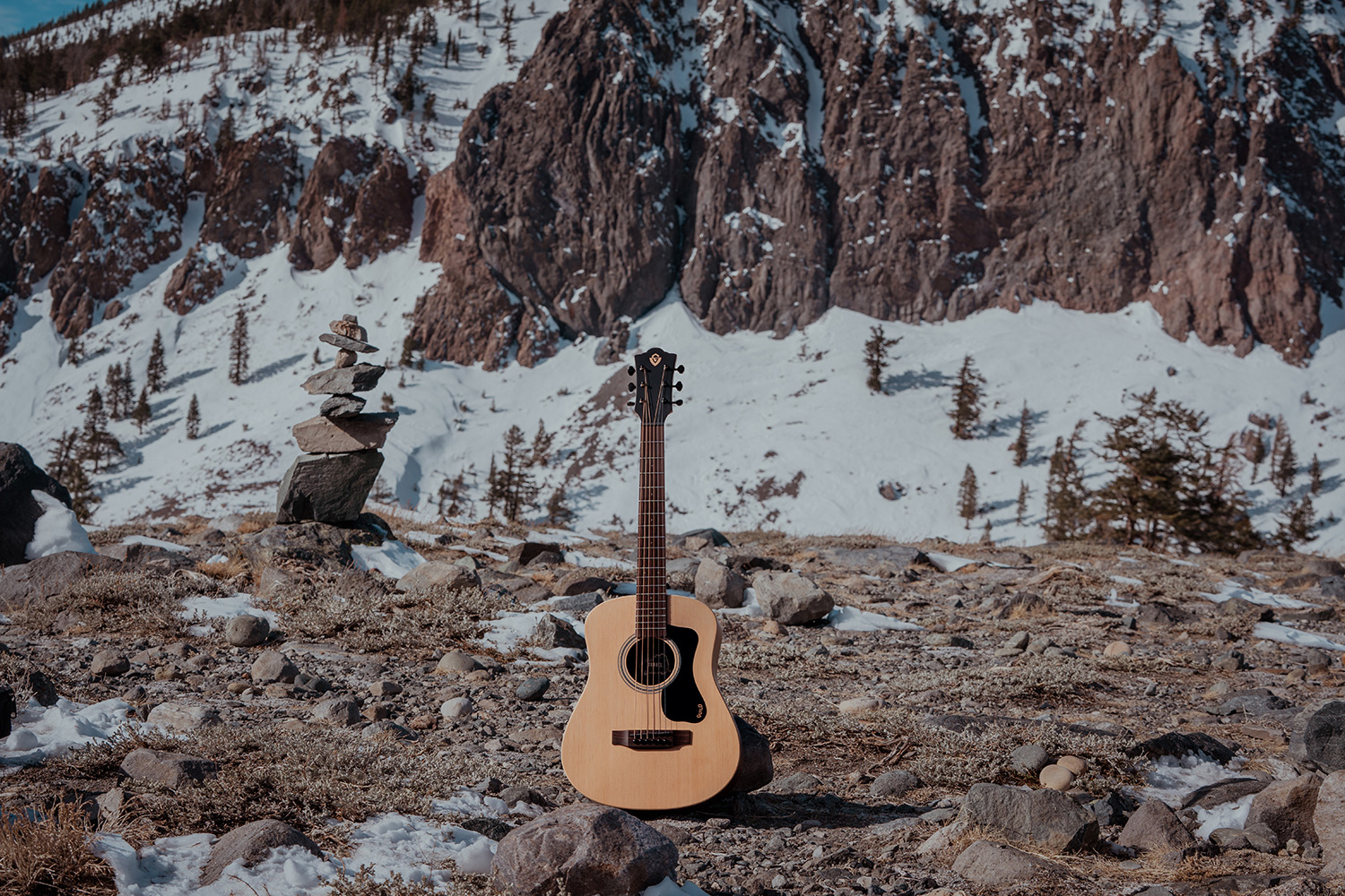 Travel Spruce acoustic guitar in a rocky snowy landscape