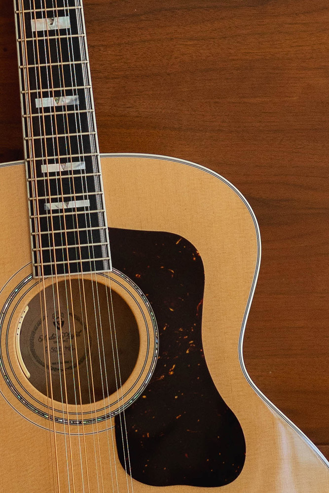 Close up of Guild F-512 Maple Blonde soundhole and pickguard