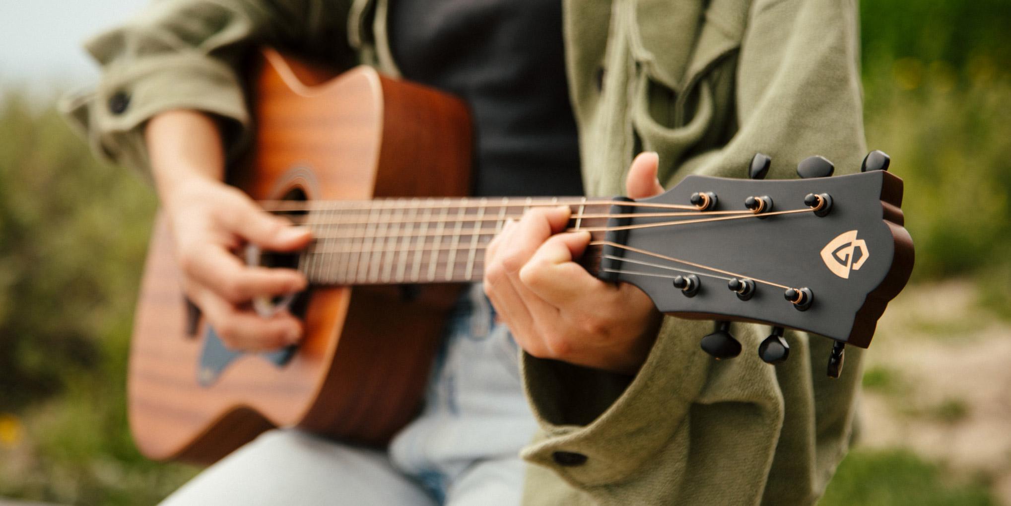 Close up of a person playing the Travel Mahogany outdoors