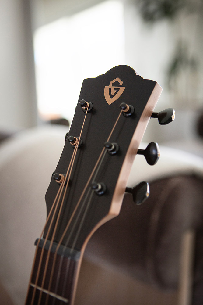 Close up of Travel Mahogany head stock with Guild logo